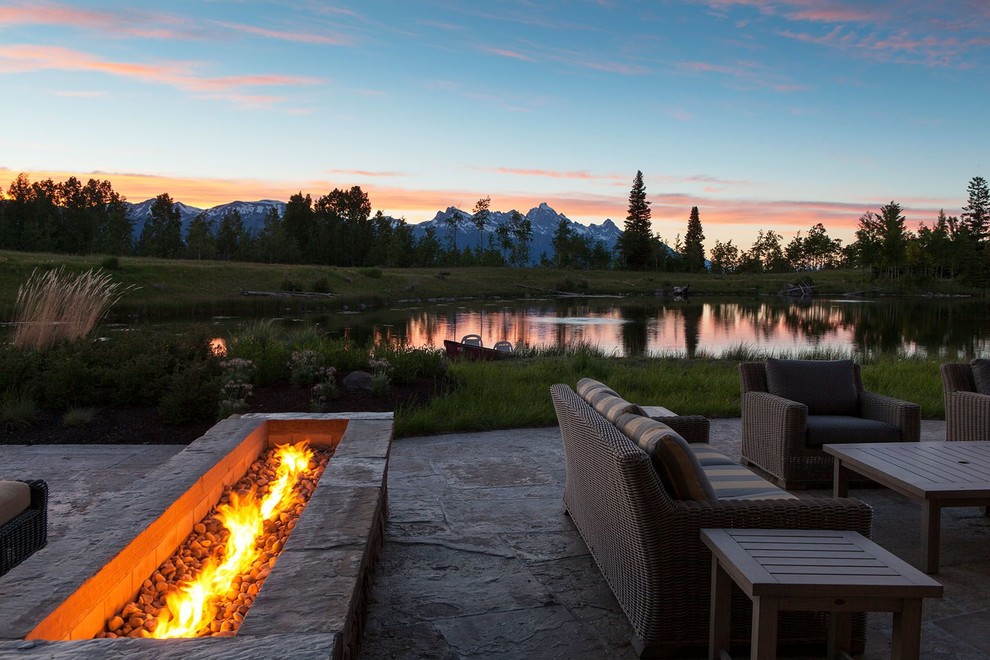 Patio - mid-sized rustic backyard stamped concrete patio idea with a fire pit and no cover