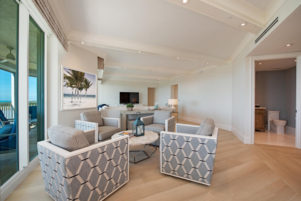 Photo of a large coastal living room in Miami with beige walls.