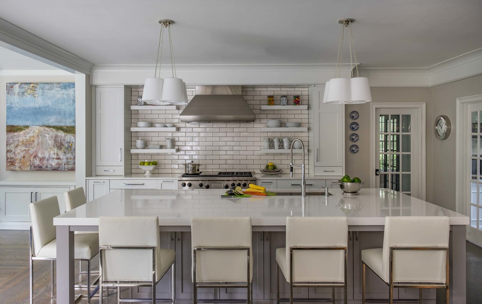 Inspiration for a transitional kitchen in Boston with white cabinets, quartz benchtops, white splashback, subway tile splashback, stainless steel appliances, an undermount sink, with island and open cabinets.