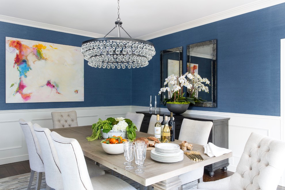 This is an example of a beach style separate dining room in San Francisco with blue walls, dark hardwood floors and no fireplace.