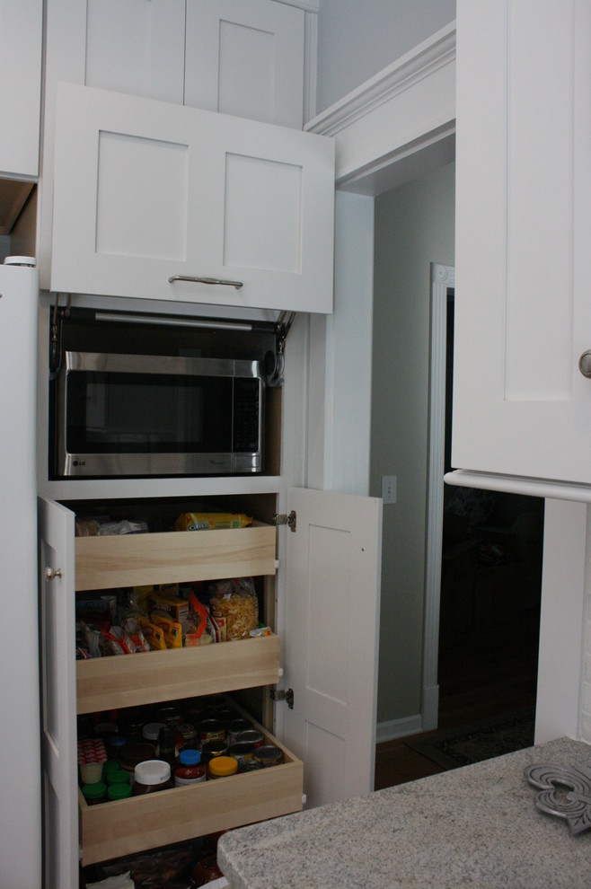 Transitional home design photo in Nashville with flat-panel cabinets, white cabinets and granite countertops