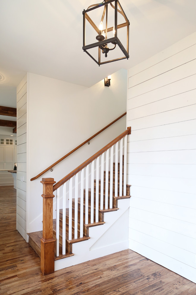 Inspiration for a mid-sized country hallway in Other with white walls and medium hardwood floors.