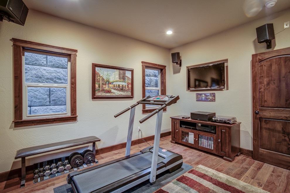 Mid-sized country multipurpose gym in Seattle with beige walls and medium hardwood floors.