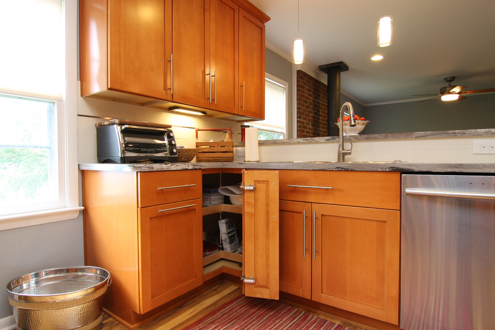 Eat-in kitchen - large transitional u-shaped medium tone wood floor eat-in kitchen idea with a drop-in sink, recessed-panel cabinets, medium tone wood cabinets, laminate countertops, white backsplash, ceramic backsplash, stainless steel appliances and a peninsula