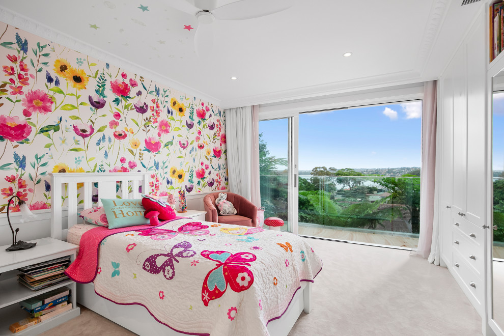 Photo of a large beach style kids' bedroom for kids 4-10 years old and girls in Sydney with multi-coloured walls, carpet, pink floor and wallpaper.