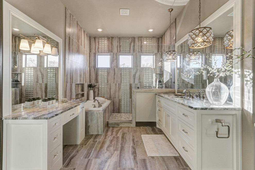 Design ideas for a large transitional master bathroom in Oklahoma City with shaker cabinets, white cabinets, a corner tub, an open shower, a one-piece toilet, beige tile, marble, beige walls, marble floors, an undermount sink, engineered quartz benchtops and an open shower.