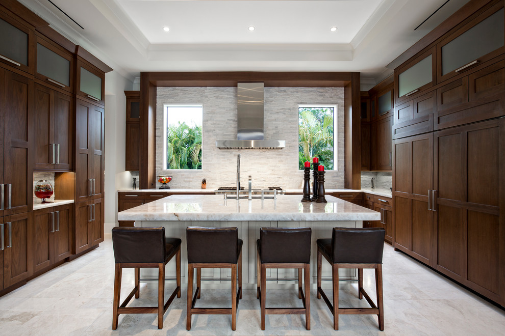 Large contemporary u-shaped kitchen in Miami with an undermount sink, recessed-panel cabinets, dark wood cabinets, marble benchtops, grey splashback, stone tile splashback, panelled appliances, marble floors and with island.