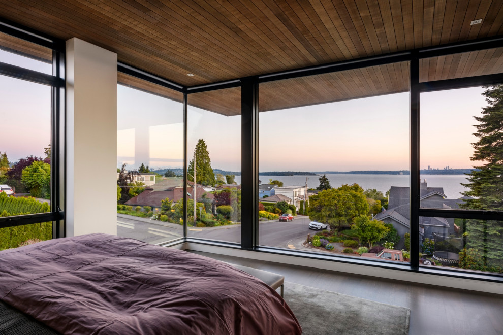 Photo of a mid-sized modern master bedroom in Seattle with light hardwood floors and wood.