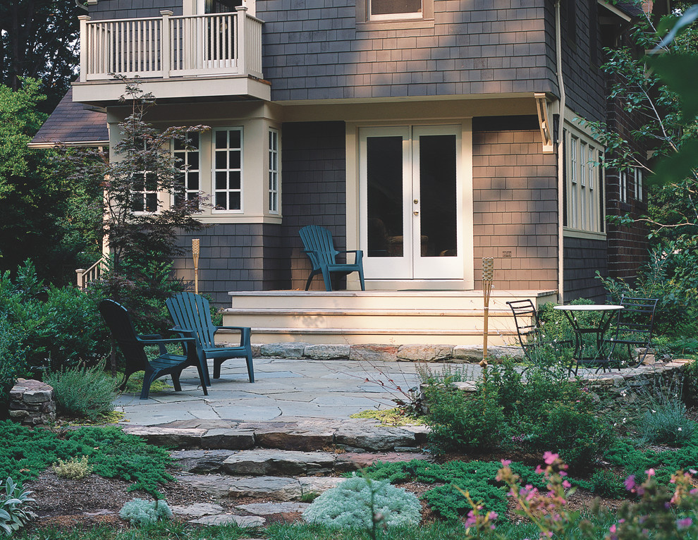 This is an example of a traditional backyard garden in New York with natural stone pavers.