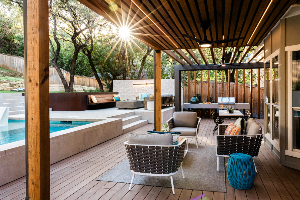 Large backyard ground level deck photo in Austin with a bbq area and a pergola
