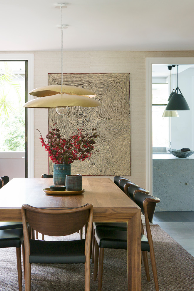 This is an example of a transitional dining room in Sydney with beige walls.