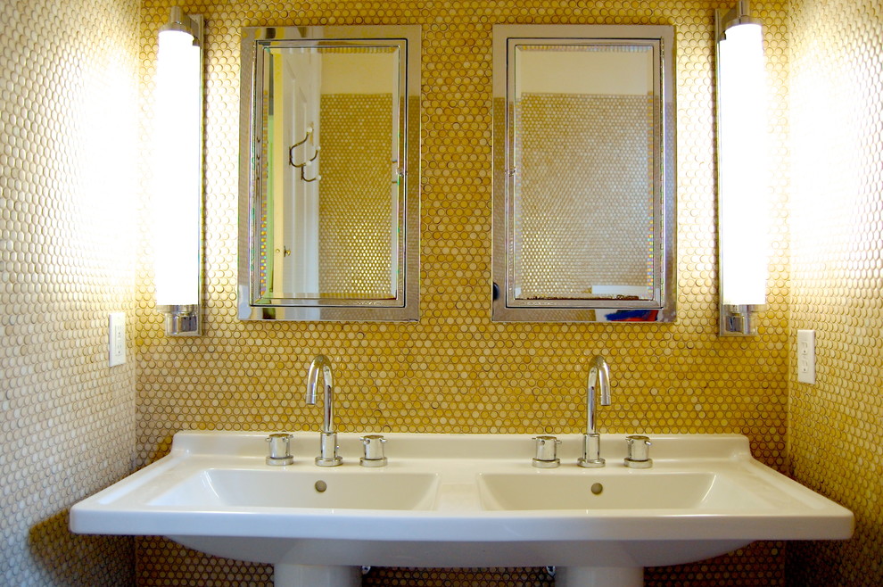 This is an example of a transitional bathroom in New York with a pedestal sink, yellow walls and yellow tile.