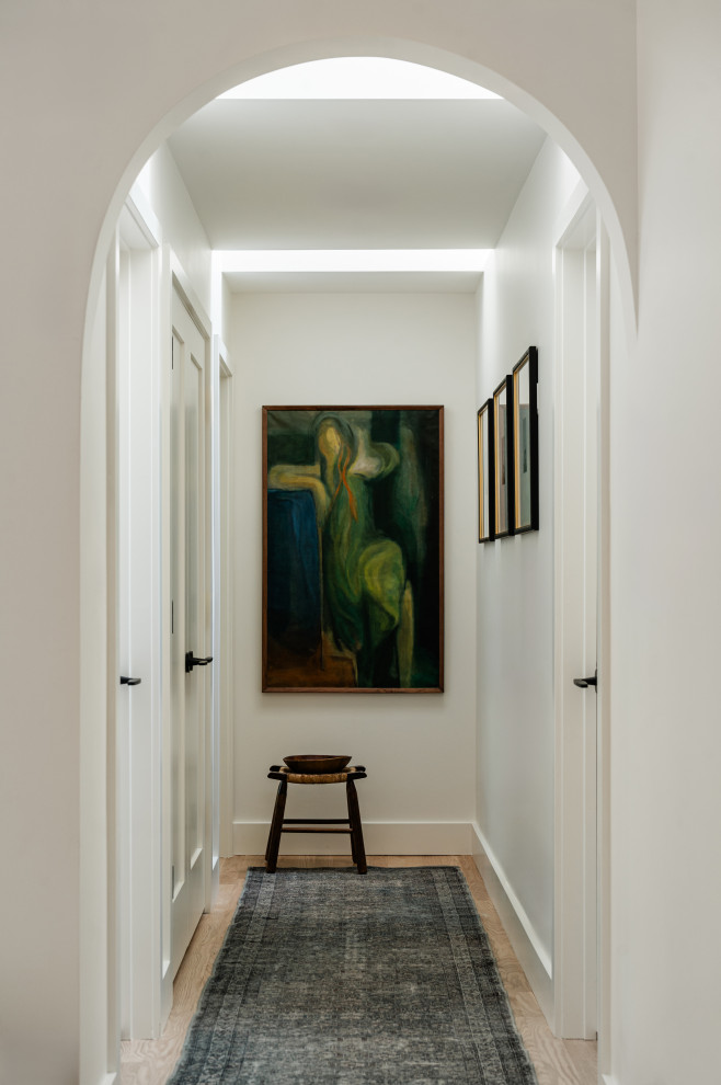 Example of a mid-sized transitional light wood floor hallway design in Chicago with white walls