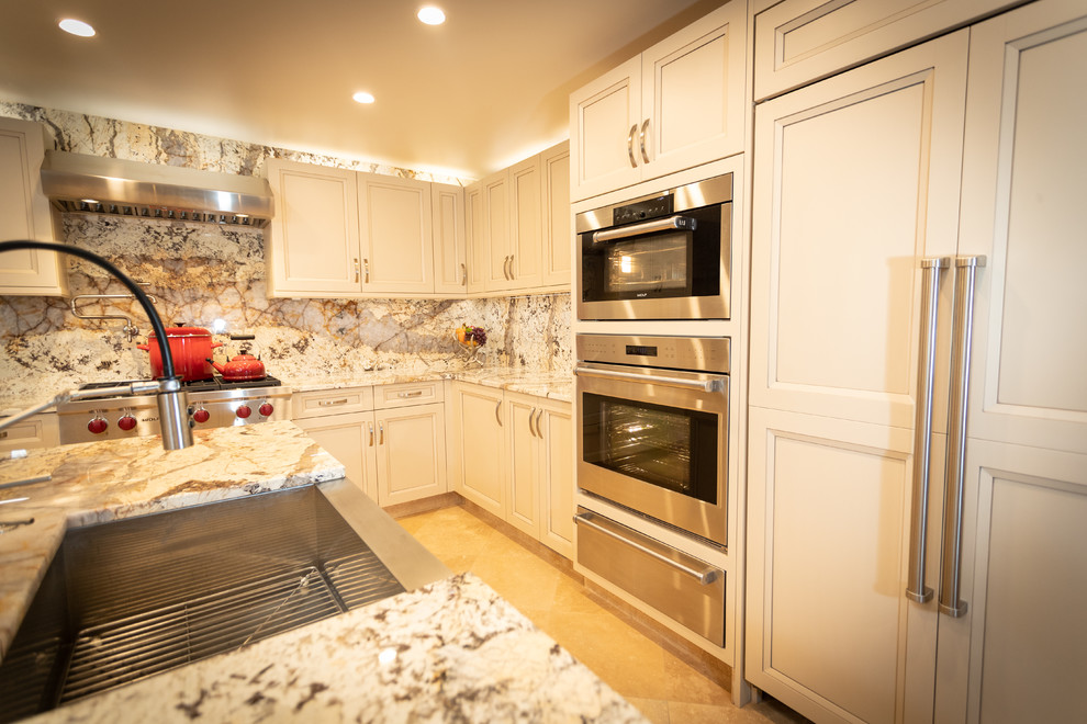 Inspiration for a mid-sized transitional u-shaped cement tile floor kitchen remodel in Atlanta with a farmhouse sink, yellow cabinets, quartzite countertops, paneled appliances, an island and multicolored countertops