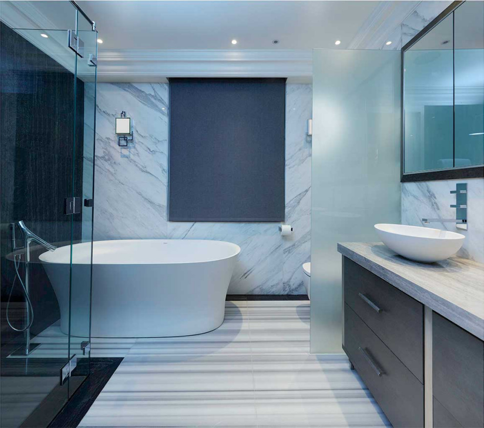 Inspiration for a medium sized contemporary grey and white ensuite bathroom in London with flat-panel cabinets, grey cabinets, a freestanding bath, a corner shower, a bidet, black and white tiles, marble tiles, multi-coloured walls, marble flooring, a vessel sink, quartz worktops, multi-coloured floors, a hinged door, grey worktops, an enclosed toilet, double sinks and a built in vanity unit.