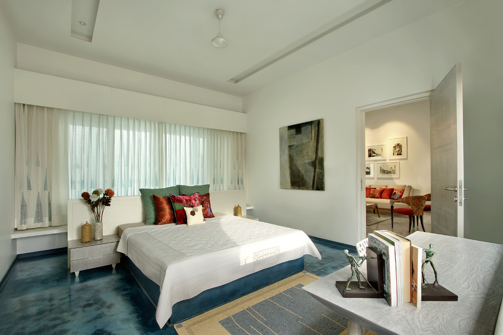 Contemporary bedroom in Ahmedabad with white walls and blue floor.