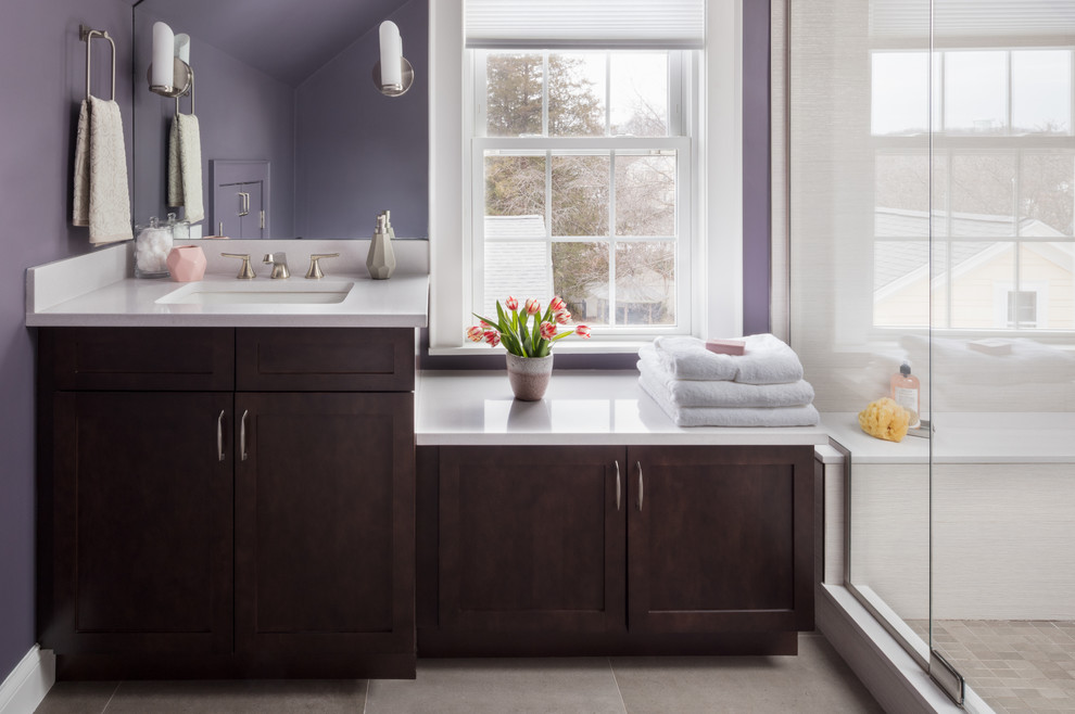 Design ideas for a mid-sized transitional master bathroom in Boston with shaker cabinets, medium wood cabinets, an alcove shower, a two-piece toilet, beige tile, ceramic tile, purple walls, ceramic floors, an undermount sink, engineered quartz benchtops, grey floor and a hinged shower door.