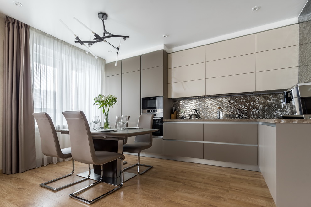 Photo of a contemporary l-shaped open plan kitchen in Moscow with flat-panel cabinets, metallic splashback, mosaic tile splashback, no island, brown floor, grey cabinets, stainless steel appliances, medium hardwood floors and beige benchtop.