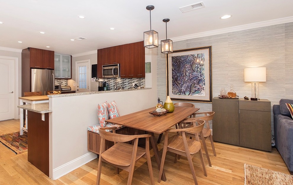 Photo of a small midcentury open plan dining in New York with grey walls, light hardwood floors and brown floor.