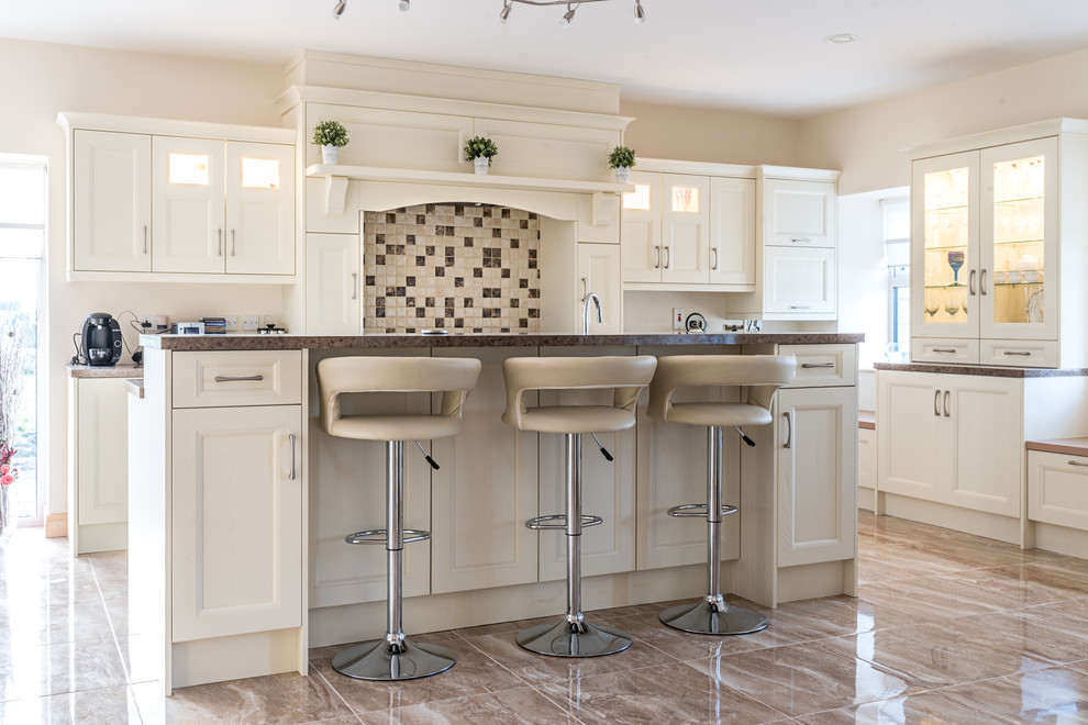 This is an example of a large transitional single-wall eat-in kitchen in Other with flat-panel cabinets, laminate benchtops, with island, beige cabinets and multi-coloured splashback.