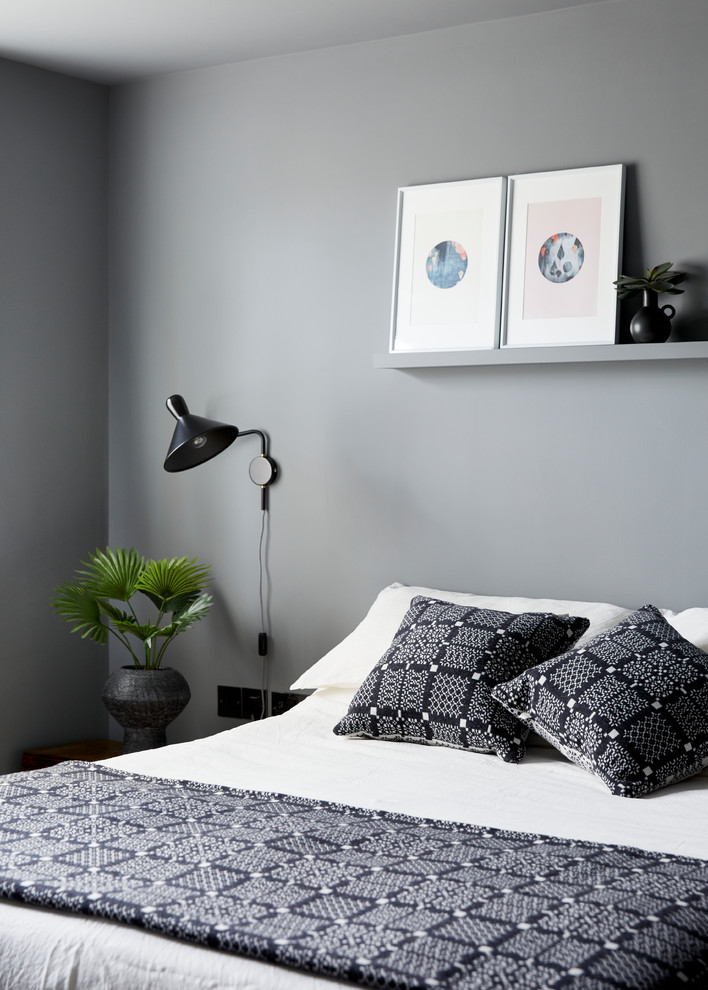 Design ideas for a contemporary master bedroom in London with grey walls.
