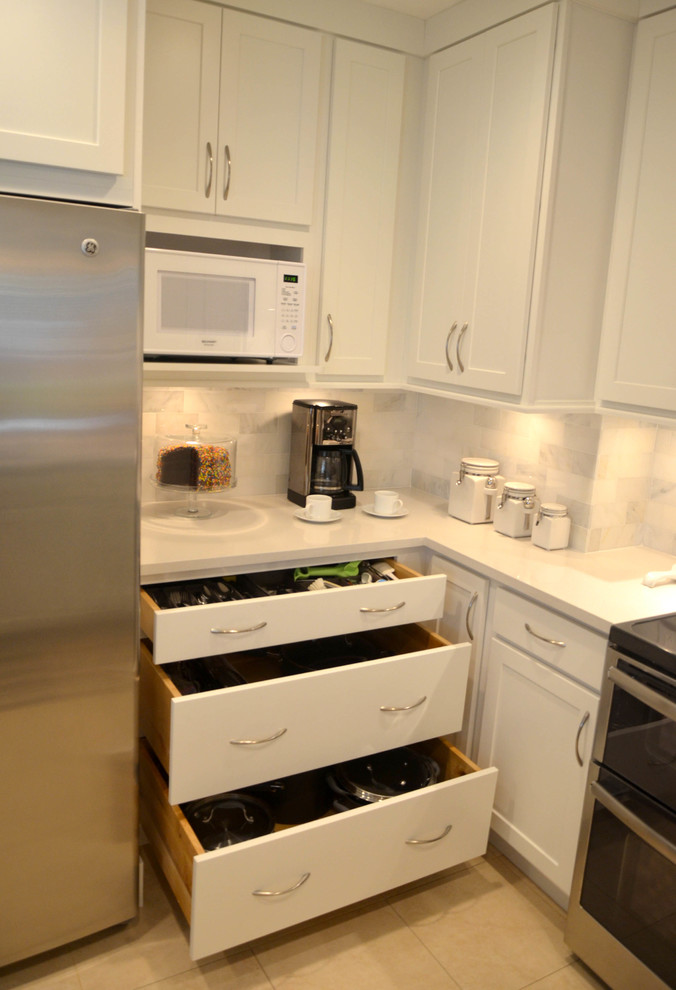 Inspiration for a small transitional u-shaped enclosed kitchen remodel in Miami with shaker cabinets, white cabinets, quartz countertops and gray backsplash