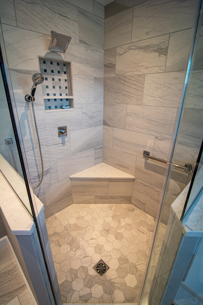 This is an example of a medium sized traditional ensuite bathroom in Philadelphia with raised-panel cabinets, blue cabinets, a built-in bath, a corner shower, a two-piece toilet, white tiles, porcelain tiles, grey walls, porcelain flooring, a submerged sink, engineered stone worktops, white floors, a hinged door, white worktops, a shower bench, double sinks and a built in vanity unit.