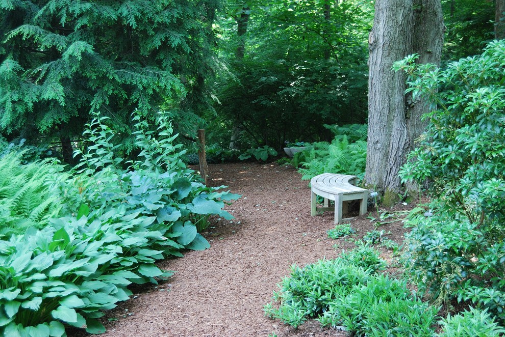 Photo of a large traditional backyard garden in New York with a garden path and gravel.