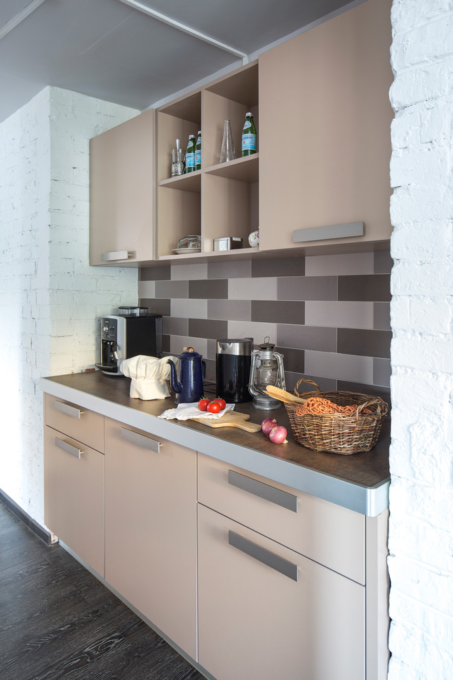 Photo of a small contemporary single-wall kitchen in Moscow with flat-panel cabinets, beige cabinets, laminate benchtops, brown splashback, no island and porcelain splashback.