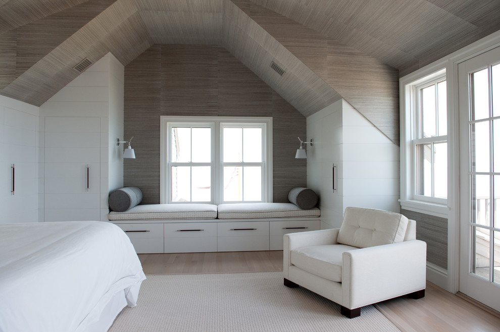 Beach style bedroom in Boston with white walls and light hardwood floors.