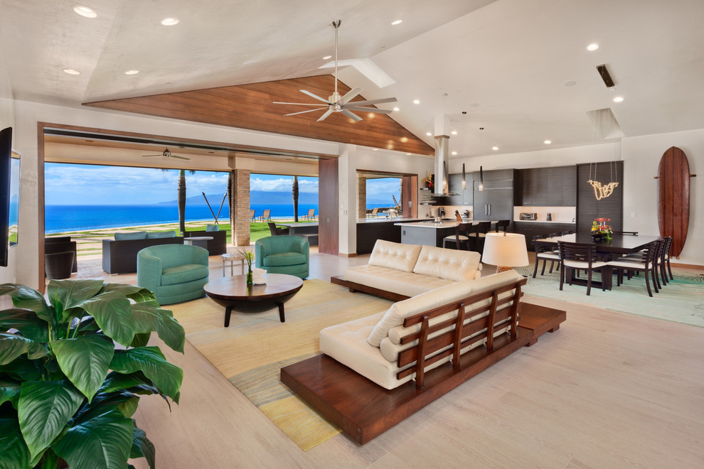Large contemporary formal open concept living room in Hawaii with white walls, light hardwood floors, no fireplace, a wall-mounted tv and beige floor.