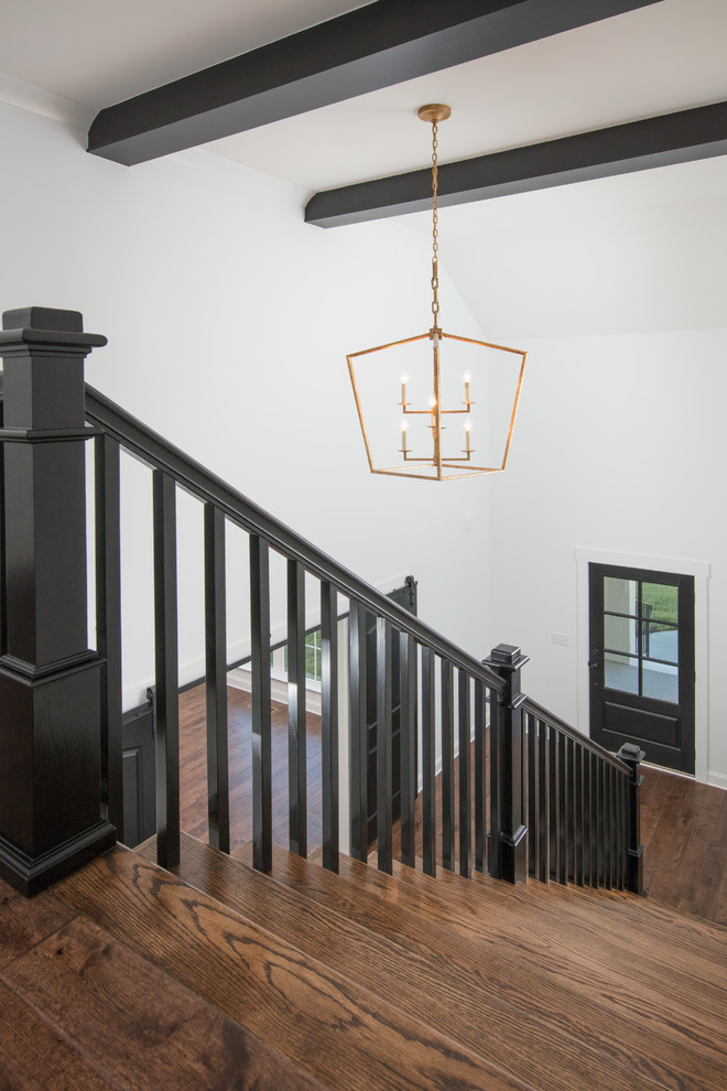 Design ideas for a large traditional wood straight staircase in Other with wood railing and painted wood risers.
