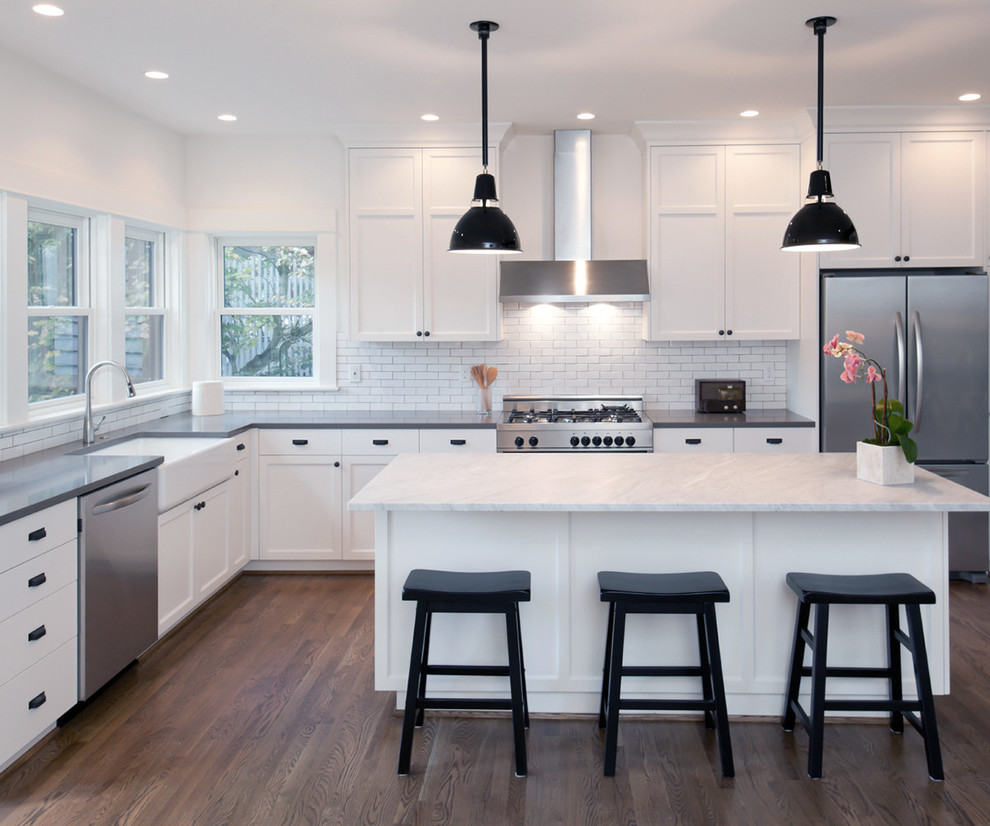 This is an example of a small modern l-shaped kitchen pantry in Los Angeles with open cabinets, white splashback, white appliances, bamboo floors, a drop-in sink and multiple islands.