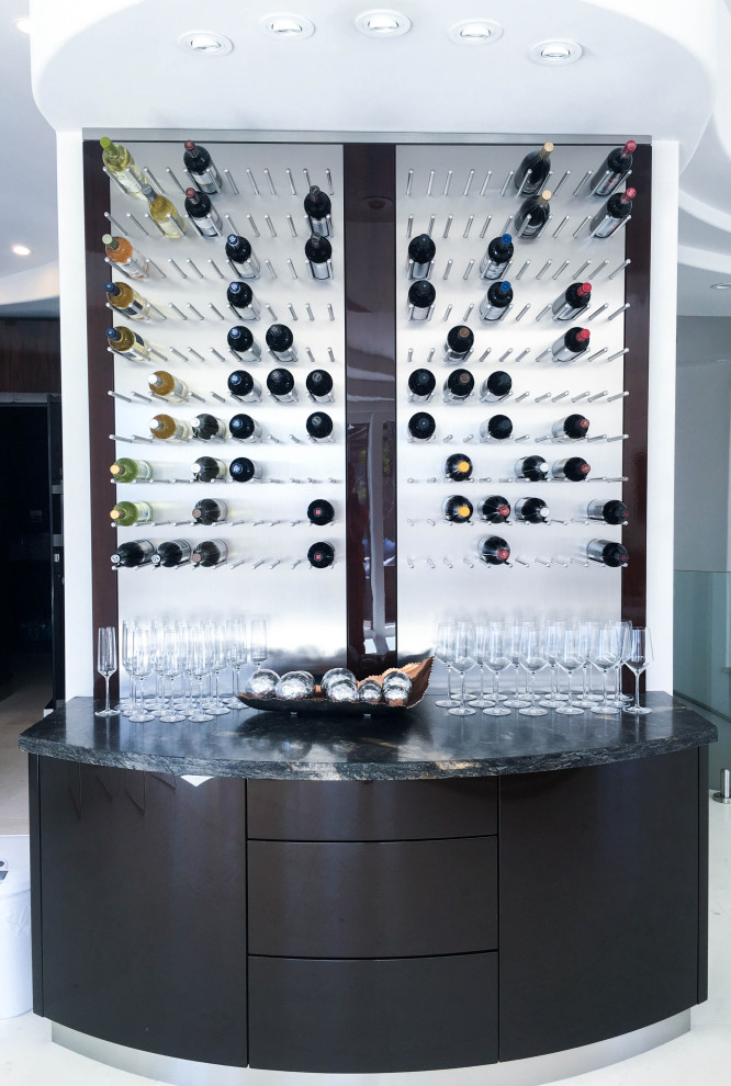 This is an example of a small contemporary wine cellar in San Diego with display racks and white floor.