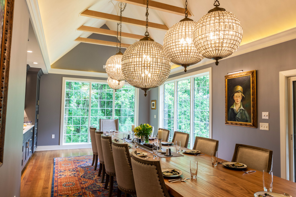 Enclosed dining room - large transitional medium tone wood floor, brown floor and exposed beam enclosed dining room idea with gray walls