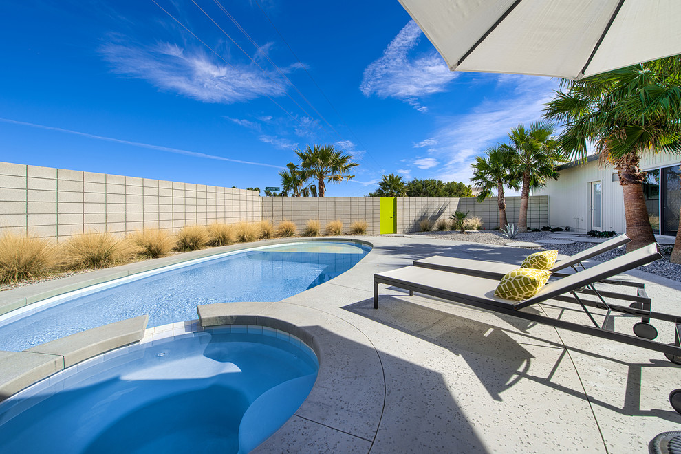 Photo of a contemporary backyard round pool in Other.