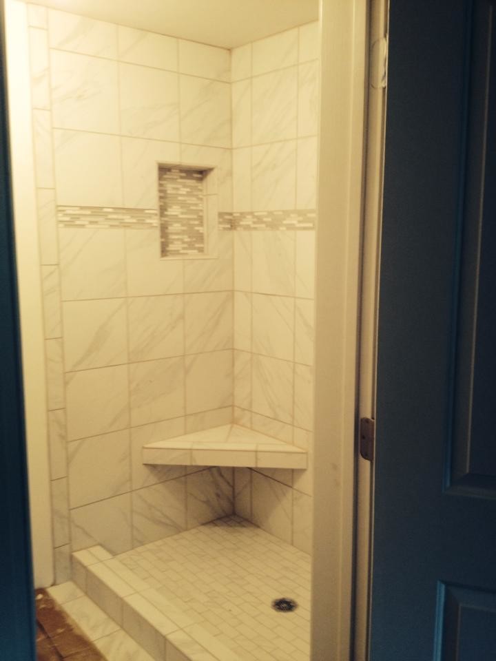 This is an example of a mid-sized contemporary master bathroom in Atlanta with an alcove shower, white tile, ceramic tile, white walls and ceramic floors.