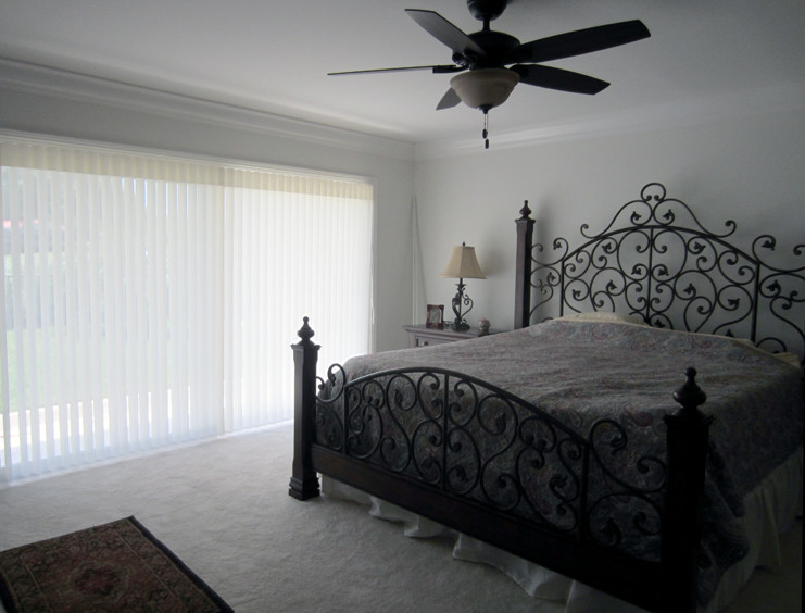 Design ideas for a traditional master bedroom in Miami with white walls and carpet.