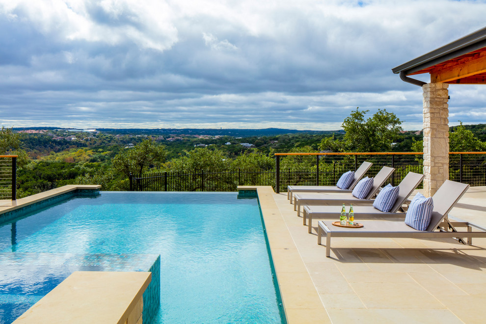 This is an example of a mid-sized country rectangular infinity pool in Austin.