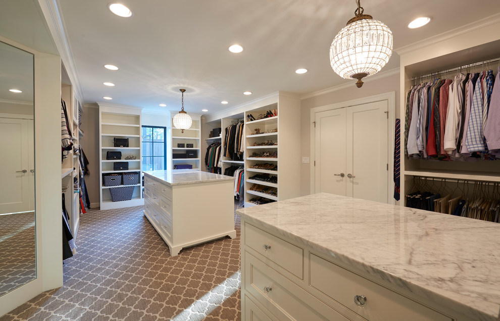 Mid-sized transitional gender-neutral walk-in wardrobe in Other with recessed-panel cabinets, medium wood cabinets and carpet.