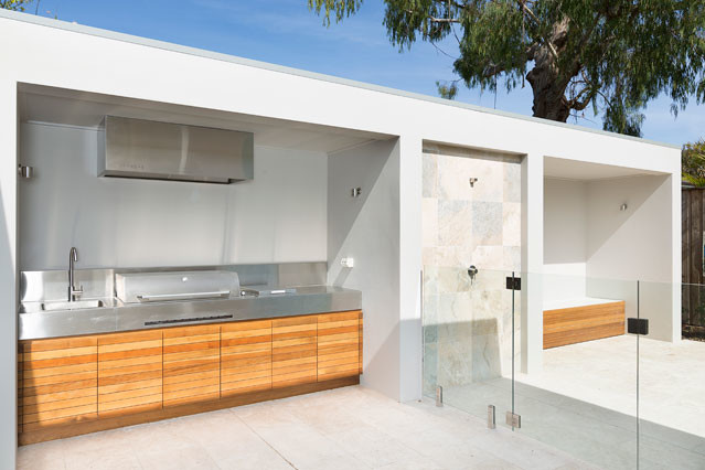 Inspiration for a contemporary backyard patio in Sydney with an outdoor shower, natural stone pavers and no cover.