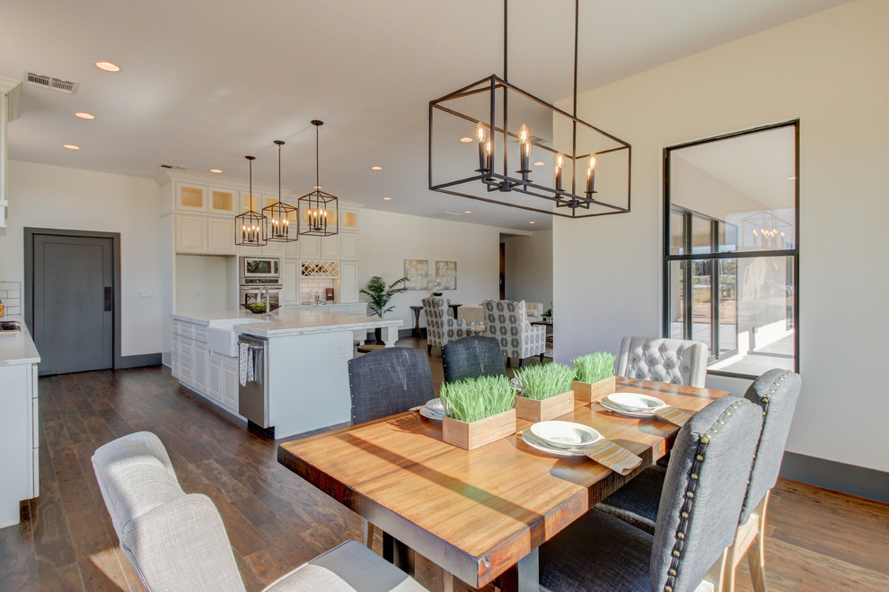 Kitchen/dining room combo - mid-sized transitional dark wood floor and brown floor kitchen/dining room combo idea in Phoenix with white walls