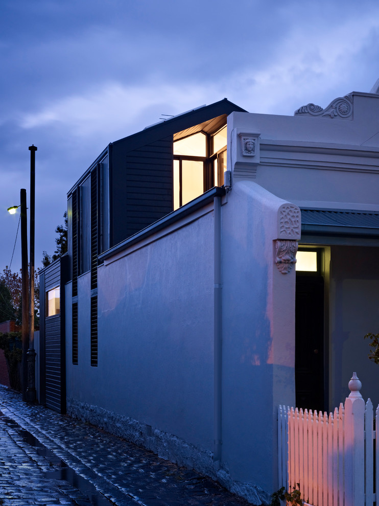 Photo of a small modern two-storey black exterior in Melbourne with wood siding and a gable roof.