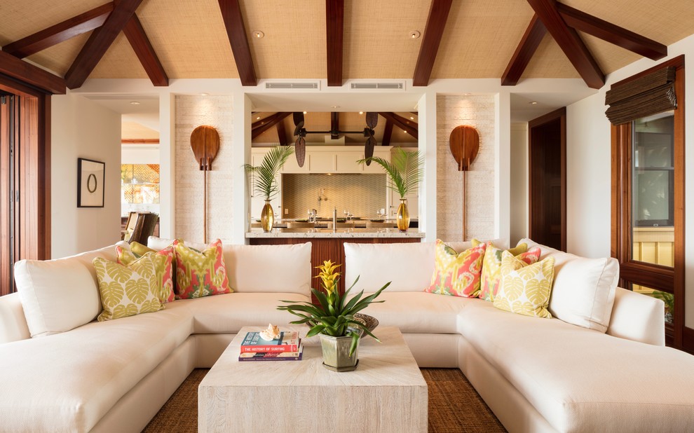 This is an example of a tropical open concept living room in Hawaii with white walls.