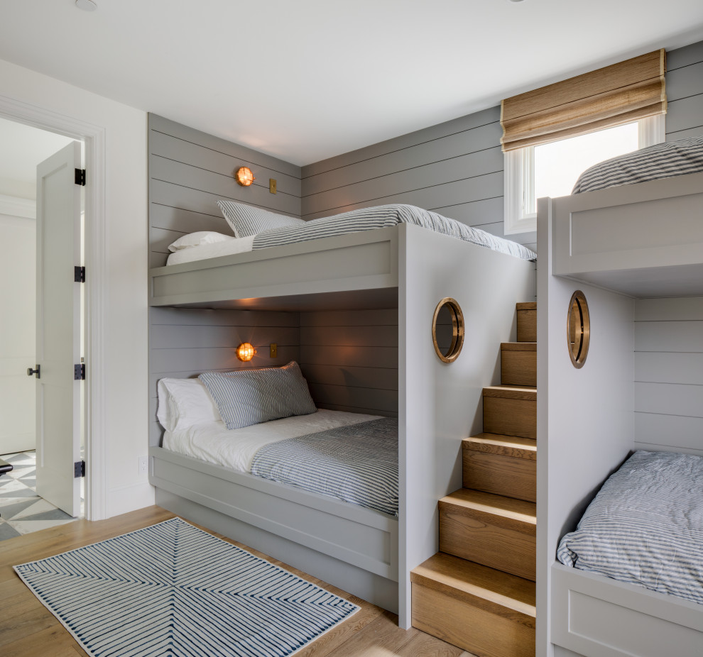 Design ideas for a beach style kids' room in Orange County with grey walls, light hardwood floors and planked wall panelling.