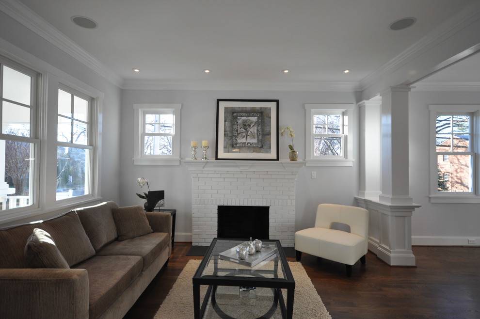 Mid-sized arts and crafts formal open concept living room in DC Metro with white walls, dark hardwood floors, a standard fireplace, a brick fireplace surround and no tv.