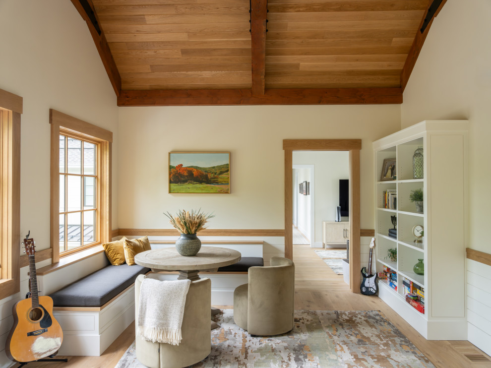 Example of a transitional light wood floor, beige floor, exposed beam, vaulted ceiling, wood ceiling, shiplap wall and wainscoting breakfast nook design in Boston with white walls and no fireplace