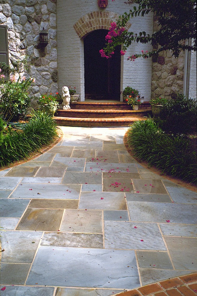 Inspiration for a large traditional front yard shaded formal garden in DC Metro with a garden path and natural stone pavers.