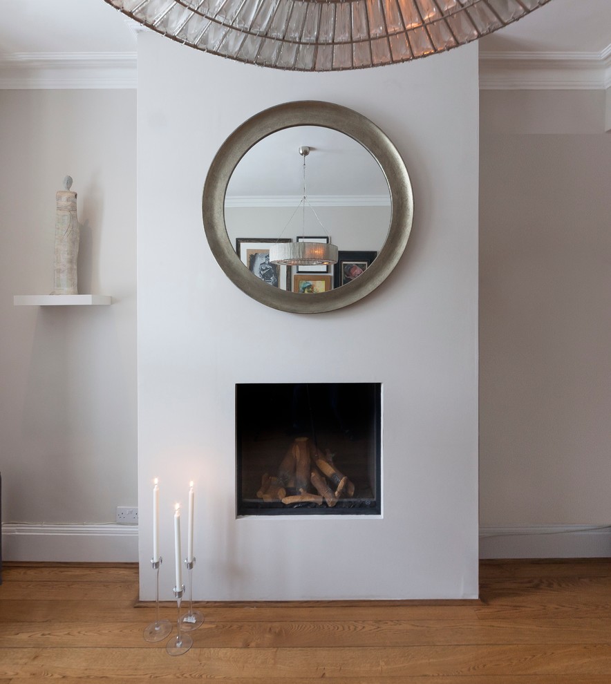 Photo of a medium sized contemporary enclosed living room in London with medium hardwood flooring.