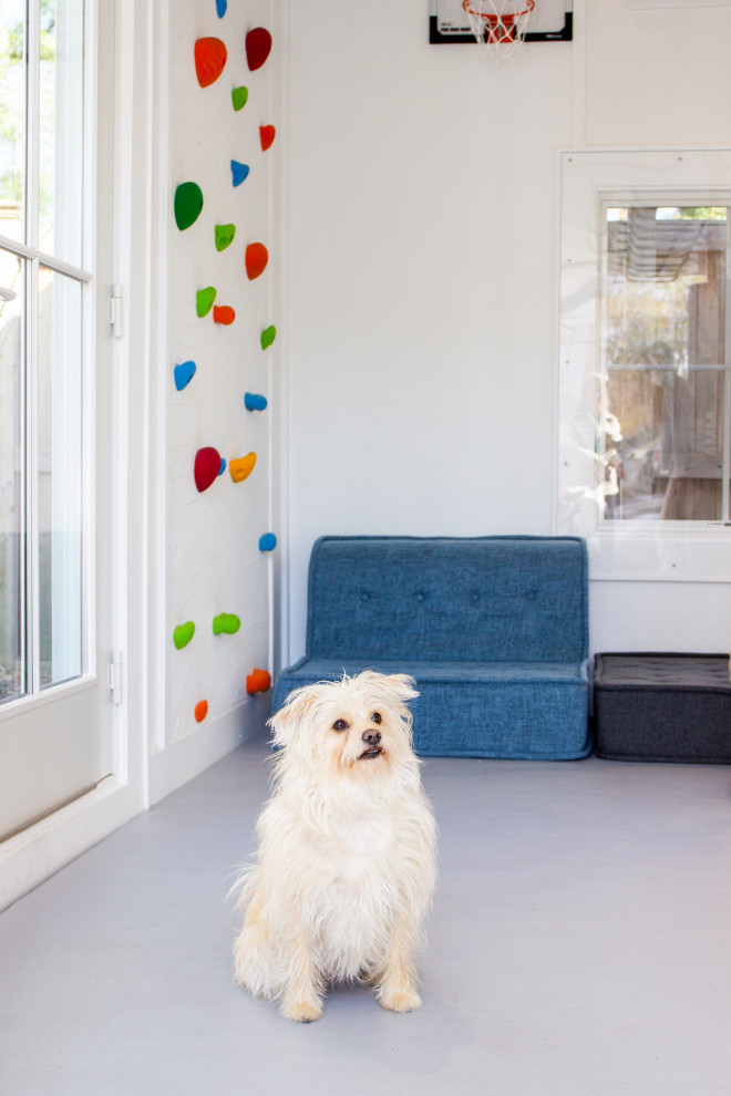 Small modern home climbing wall in New York with white walls and grey floor.